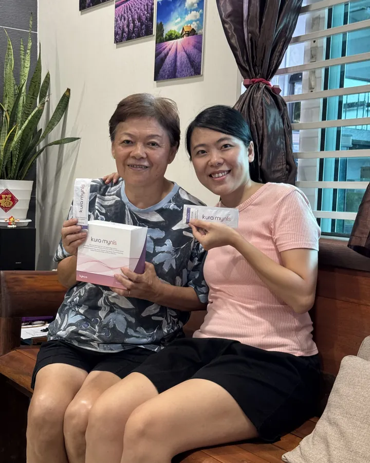 Kura Mynis customer holding a sachet